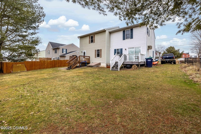 rear view of property with a lawn and fence