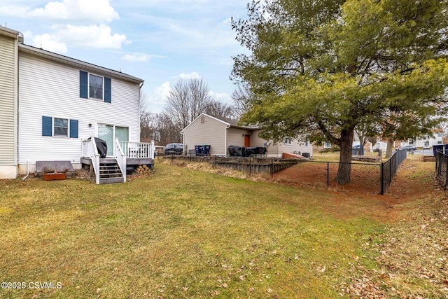 view of yard with a wooden deck and fence