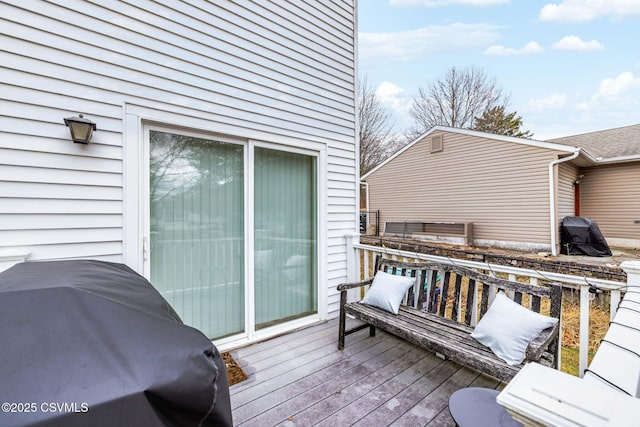 wooden terrace featuring a grill