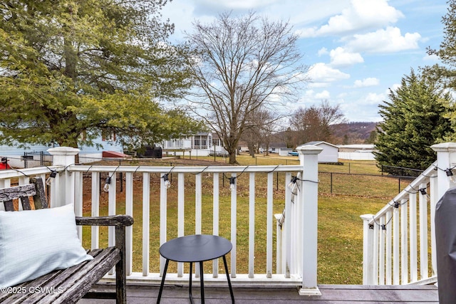 deck with a yard and fence