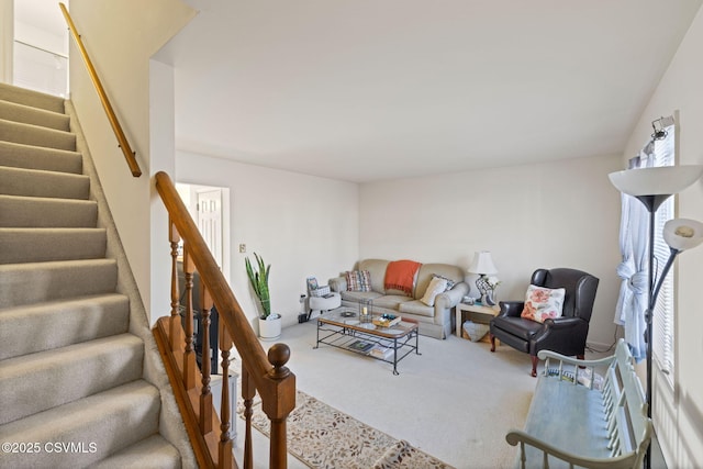 carpeted living room featuring a wealth of natural light and stairs