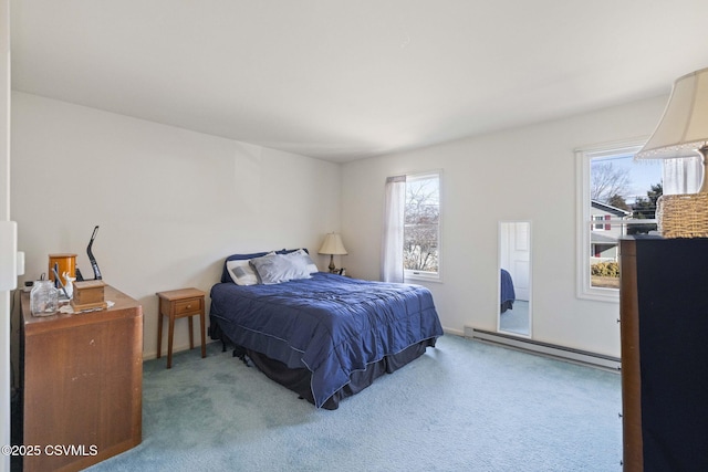 bedroom with baseboard heating and carpet floors