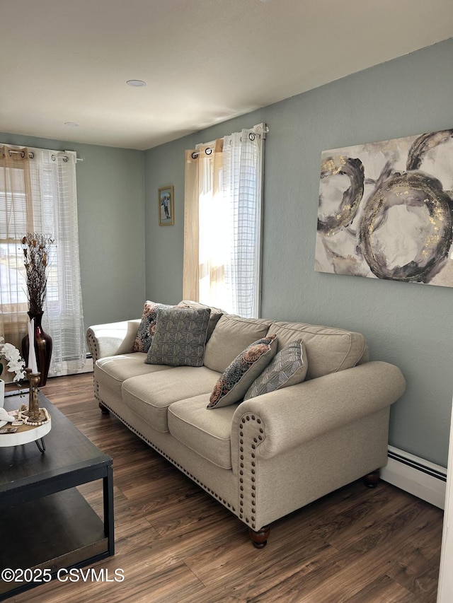 living room featuring baseboard heating and wood finished floors