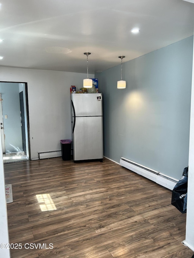 interior space with dark wood-style flooring and baseboard heating