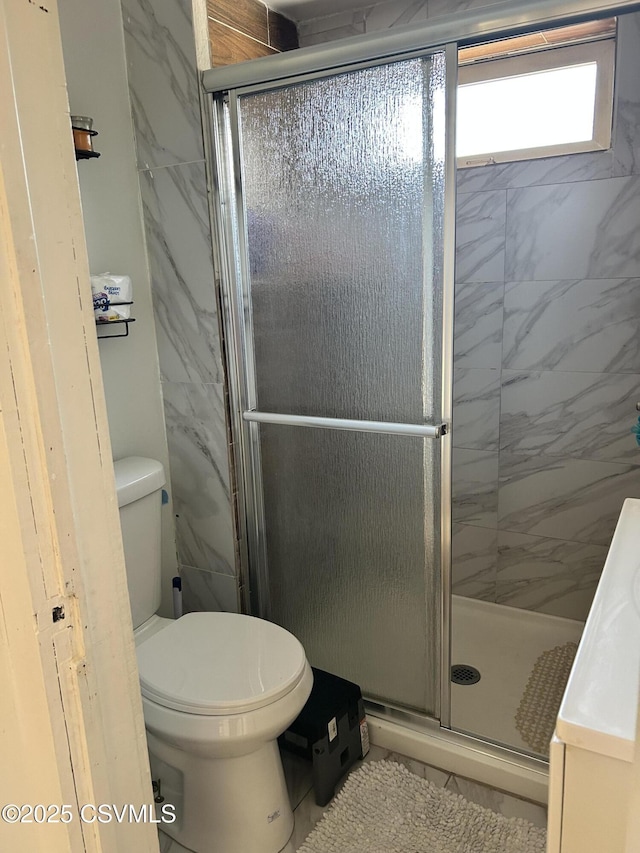 full bath featuring toilet and a stall shower