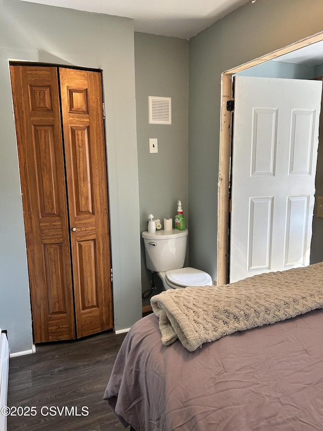 bedroom with visible vents, baseboards, and dark wood-style flooring