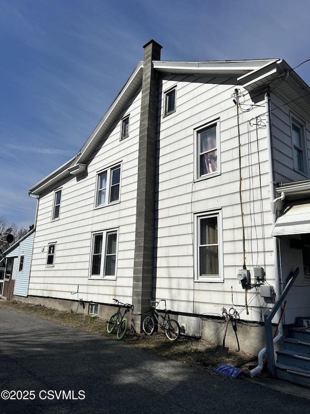 view of property exterior with a chimney