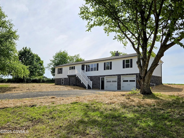 36 Starner Rd, Danville, PA 17821 - view of front facade featuring an attached garage, stairs, stone siding, and driveway