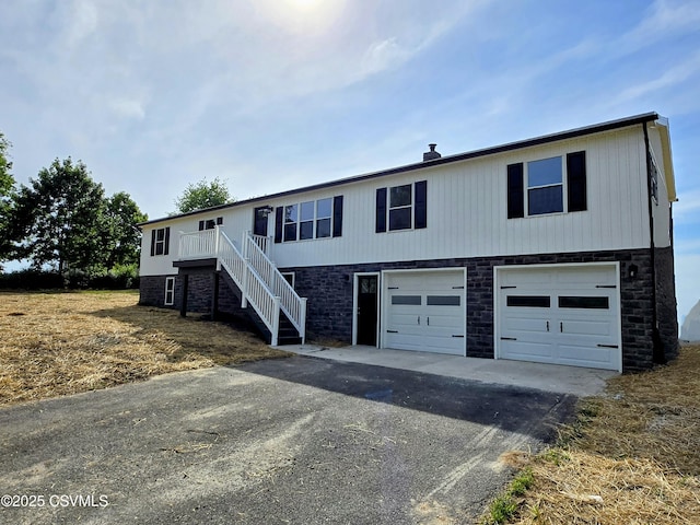 36 Starner Rd, Danville, PA 17821 - view of front of house with asphalt driveway, an attached garage, stairway, and stone siding