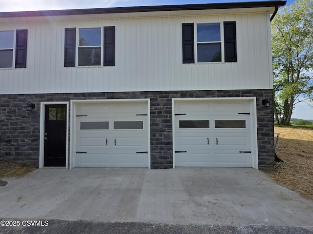 36 Starner Rd, Danville, PA 17821 - view of front of property featuring stone siding, an attached garage, and concrete driveway