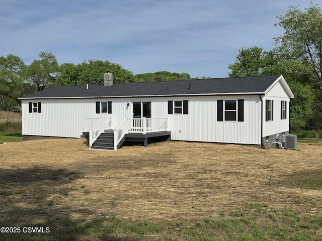36 Starner Rd, Danville, PA 17821 - back of property featuring a wooden deck, central AC unit, a chimney, and roof with shingles