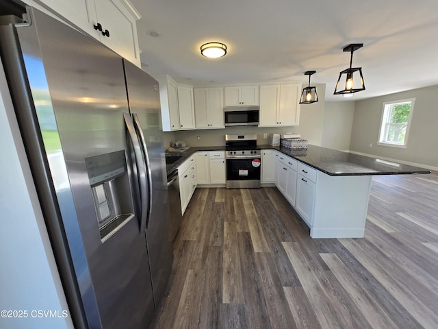36 Starner Rd, Danville, PA 17821 - kitchen featuring appliances with stainless steel finishes, a peninsula, dark countertops, dark wood finished floors, and white cabinetry