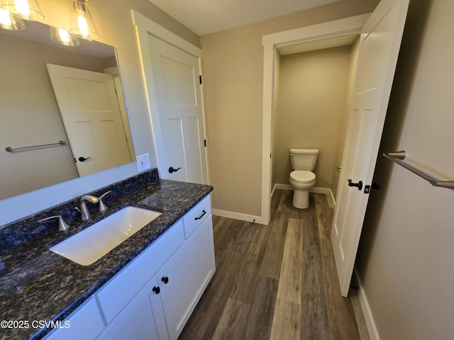 36 Starner Rd, Danville, PA 17821 - bathroom featuring wood finished floors, toilet, baseboards, and vanity