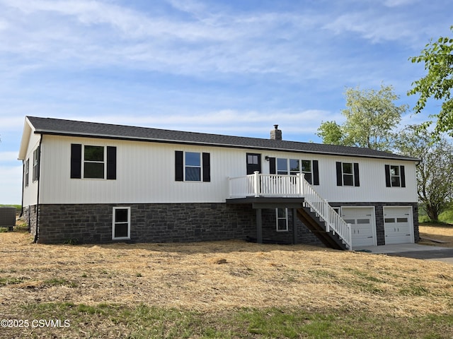 36 Starner Rd, Danville, PA 17821 - view of front of home with concrete driveway, stairway, a garage, cooling unit, and a deck