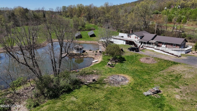 bird's eye view featuring a water view and a wooded view