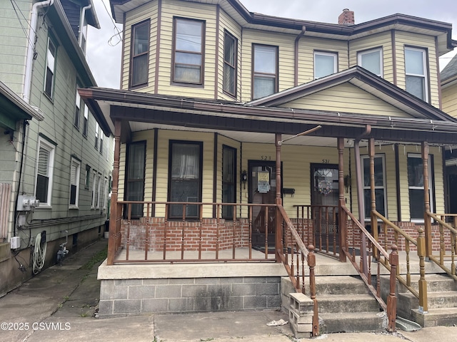 523 Race St, Sunbury, PA 17801 - view of front of house featuring covered porch and a chimney