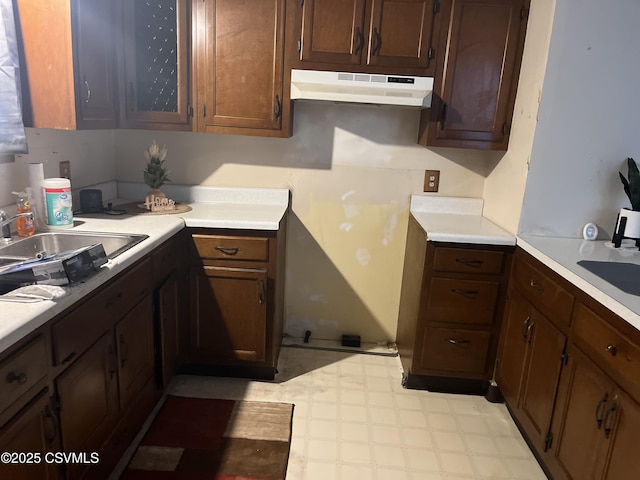 523 Race St, Sunbury, PA 17801 - kitchen featuring a sink, light floors, under cabinet range hood, and light countertops