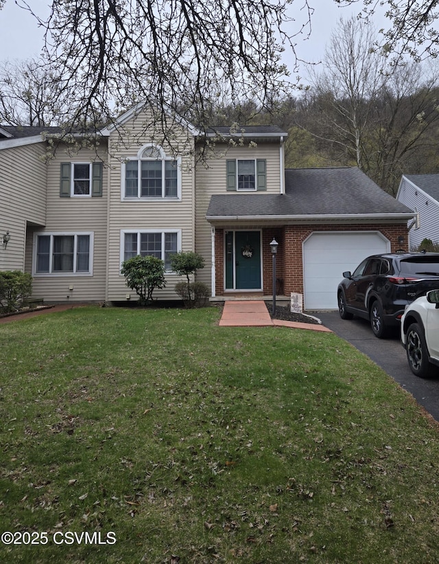 495 Meadow Ln, Danville, PA 17821 - traditional-style house featuring an attached garage, brick siding, a front lawn, and asphalt driveway