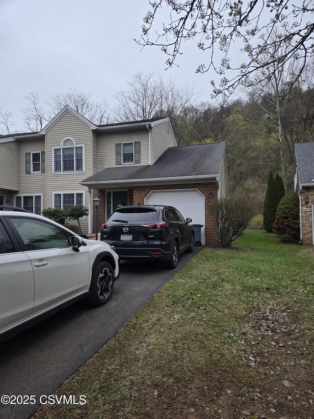 495 Meadow Ln, Danville, PA 17821 - view of front facade with an attached garage, asphalt driveway, brick siding, and a front yard