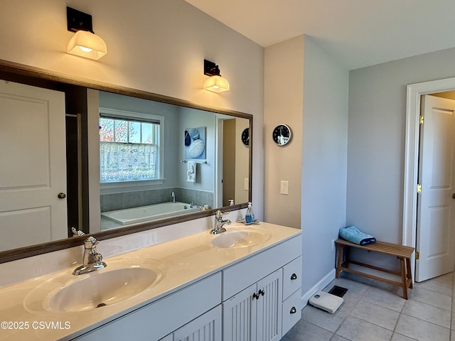 bathroom with tile patterned floors, double vanity, a garden tub, and a sink