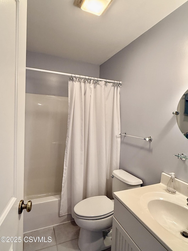 bathroom featuring tile patterned flooring, shower / tub combo with curtain, vanity, and toilet