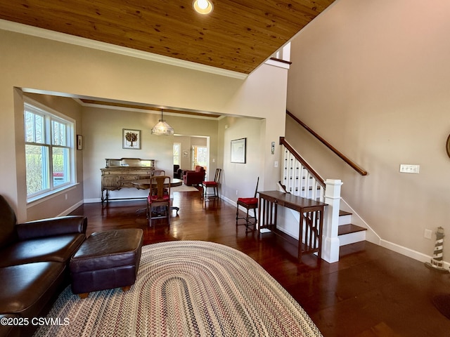 living area with baseboards, ornamental molding, stairs, wood ceiling, and wood finished floors