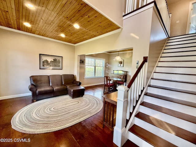 living room with ornamental molding, wooden ceiling, wood finished floors, and stairs