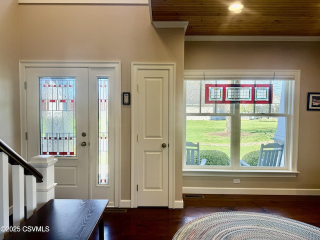 foyer with dark wood-style floors, baseboards, and ornamental molding