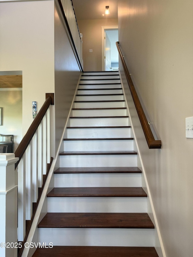 stairway featuring baseboards
