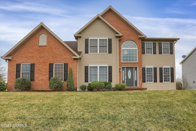 colonial house featuring a front yard and brick siding