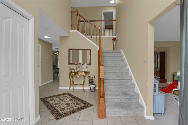 stairway featuring baseboards and tile patterned flooring