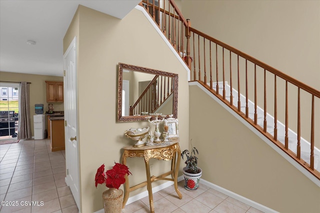 staircase with baseboards and tile patterned flooring