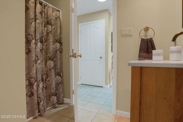 bathroom with baseboards, tile patterned flooring, and a shower with curtain