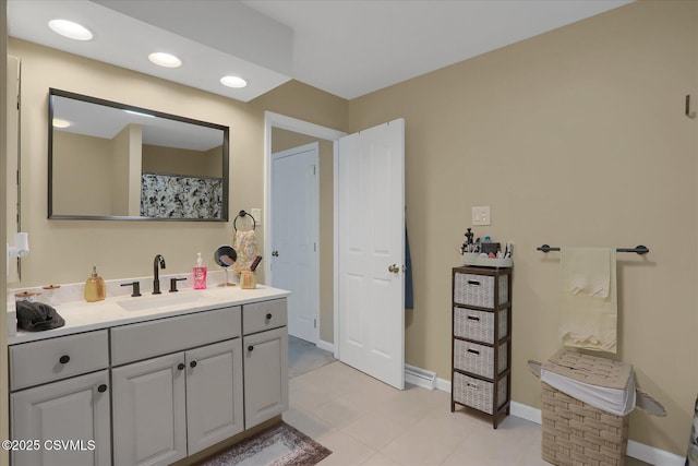 bathroom with baseboards, recessed lighting, and vanity
