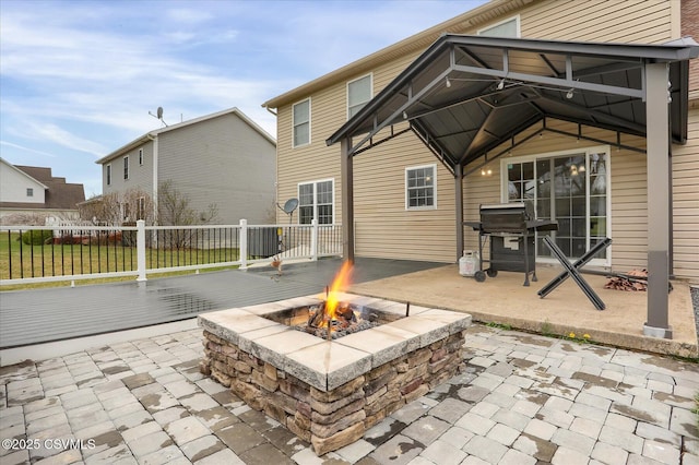 view of patio featuring an outdoor fire pit, fence, and area for grilling