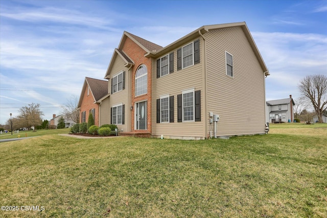 colonial-style house with a front lawn