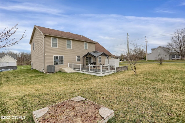 back of property featuring central air condition unit and a lawn