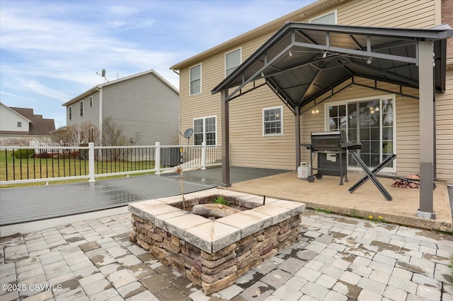 view of patio featuring a grill and fence