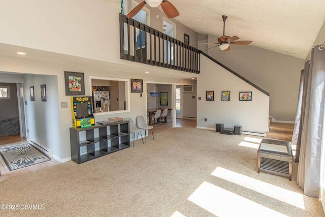 carpeted living room with baseboard heating, high vaulted ceiling, a ceiling fan, and stairs