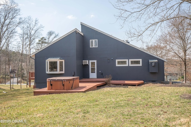 back of house with a wooden deck, a hot tub, and a lawn