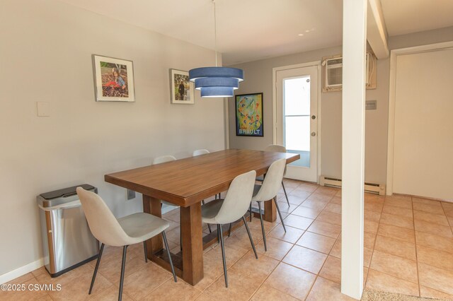 dining space with baseboard heating, a wall mounted AC, and light tile patterned floors