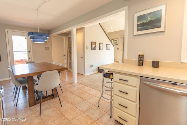 dining room with light tile patterned floors and baseboards