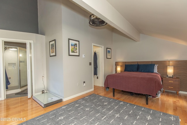 bedroom featuring baseboards, wood finished floors, and lofted ceiling with beams