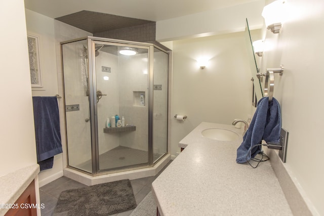 full bath with tile patterned floors, vanity, and a stall shower