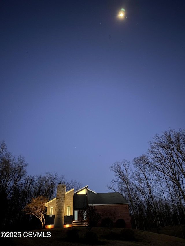 view of property exterior featuring a chimney
