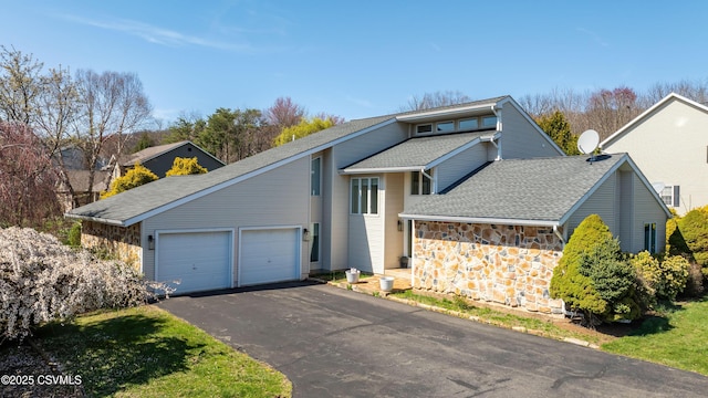 87 Lindsey Ave, Danville, PA 17821 - mid-century modern home with an attached garage, a shingled roof, driveway, and stone siding
