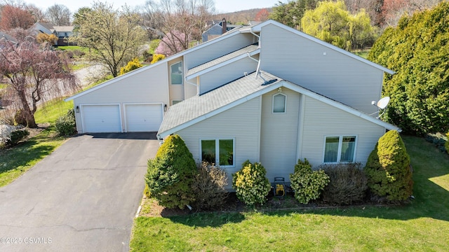 87 Lindsey Ave, Danville, PA 17821 - exterior space featuring an attached garage, a shingled roof, a lawn, and driveway