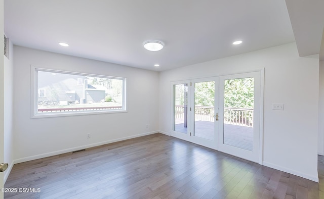 87 Lindsey Ave, Danville, PA 17821 - spare room with visible vents, baseboards, recessed lighting, wood finished floors, and french doors