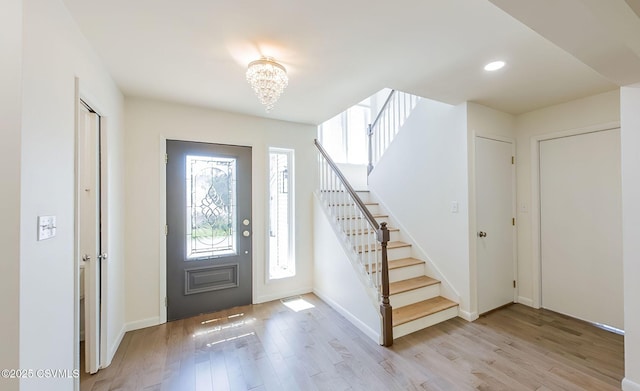 87 Lindsey Ave, Danville, PA 17821 - foyer entrance with light wood-type flooring, plenty of natural light, a notable chandelier, and stairs