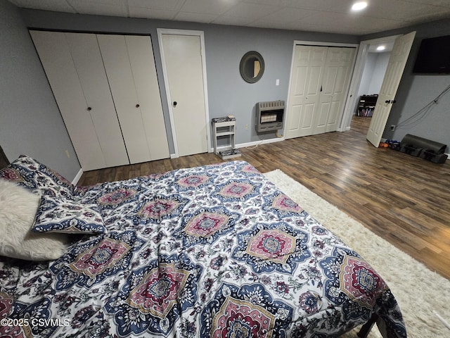 444 Frederick Dr, Watsontown, PA 17777 - bedroom featuring two closets, baseboards, heating unit, and wood finished floors